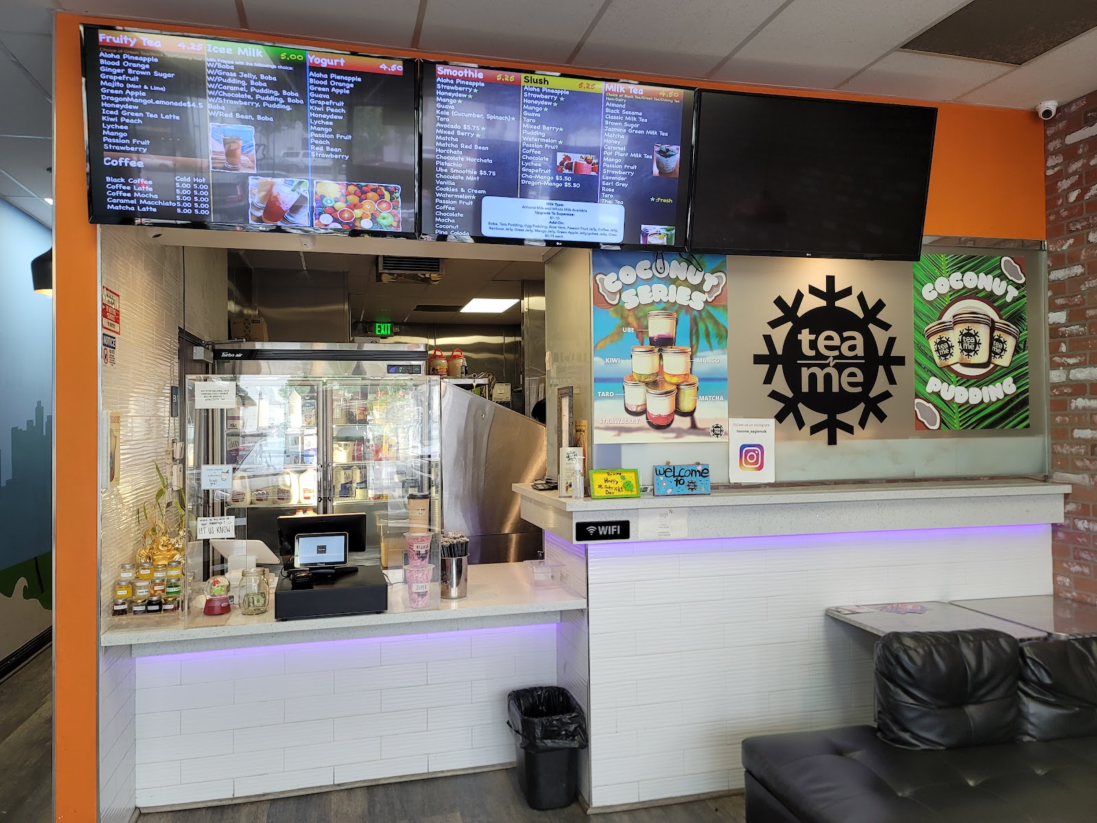 Inside the Tea N' Me shop with warm wood counters and hanging plants